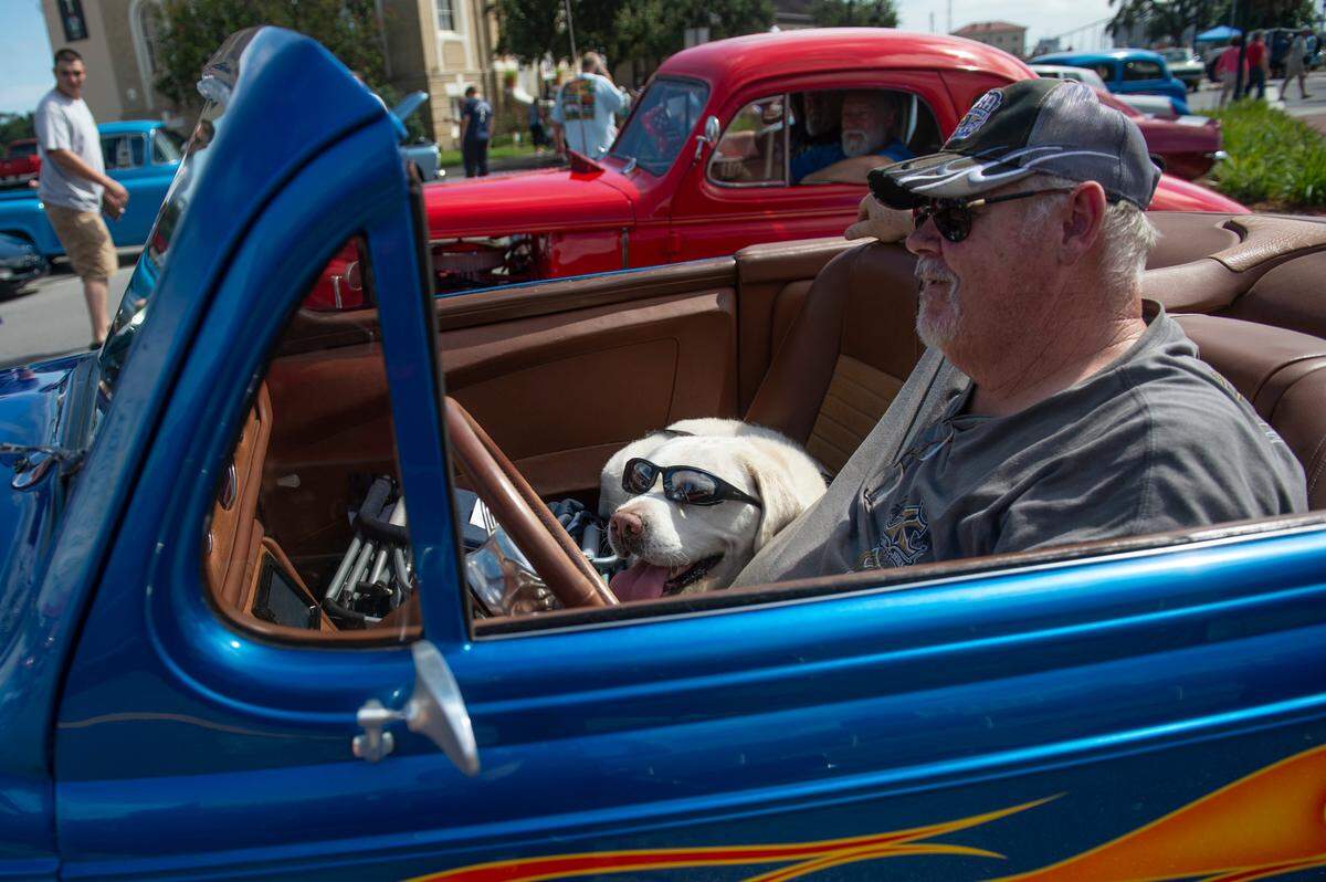 Eric Knight and his dog Cody sit in his classic car during View the Cruise in downtown Gulfport on Sunday, Oct. 3, 2021.