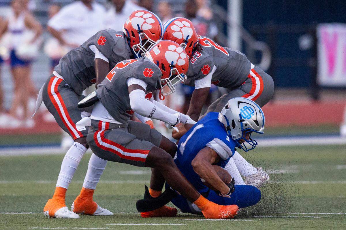 Ocean Springs’ Jax Coleman gets tackled by Madison Central during a game against Madison Central at Greyhound Stadium in Ocean Springs on Friday, Aug. 30, 2024.