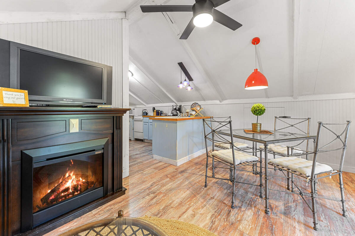 The upstairs apartment on the Breezy Porches property features an open floor plan with one bedroom off the kitchen.