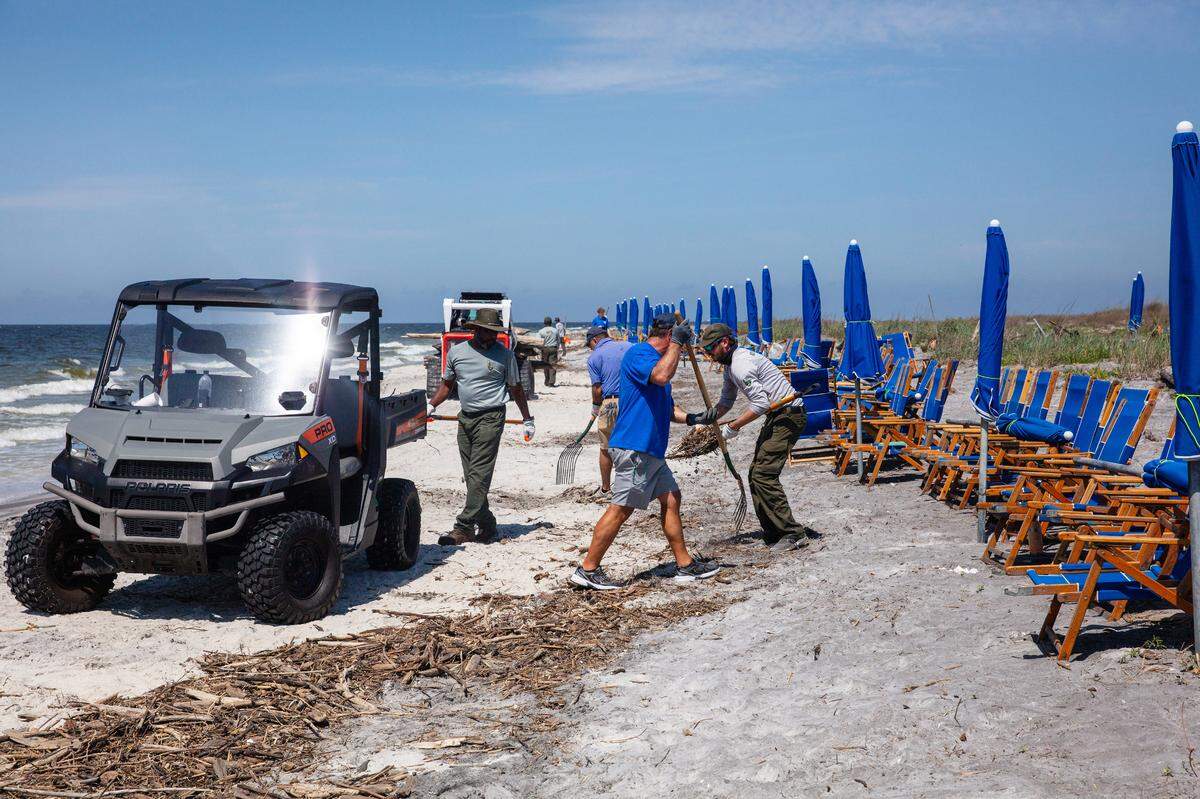 Fifteen employees of the National Park Service, along with four workers from Ship Island Excursions ferry service out of Gulfport, recently worked to clean debris from flooding off the barrier island beach enjoyed by residents and tourists.