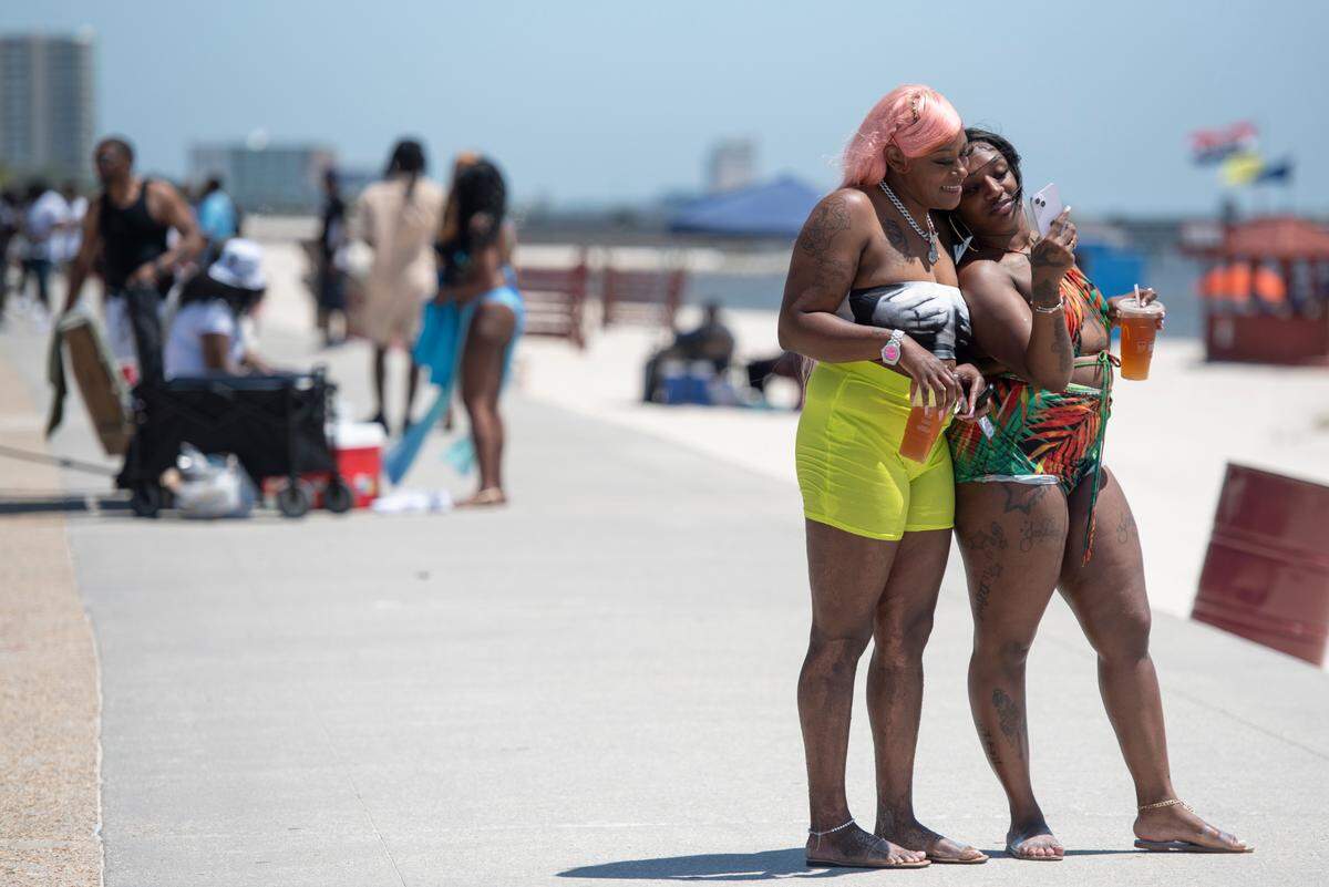 Spring breakers take photos during Black Spring Break in Biloxi on Saturday, April 13, 2024