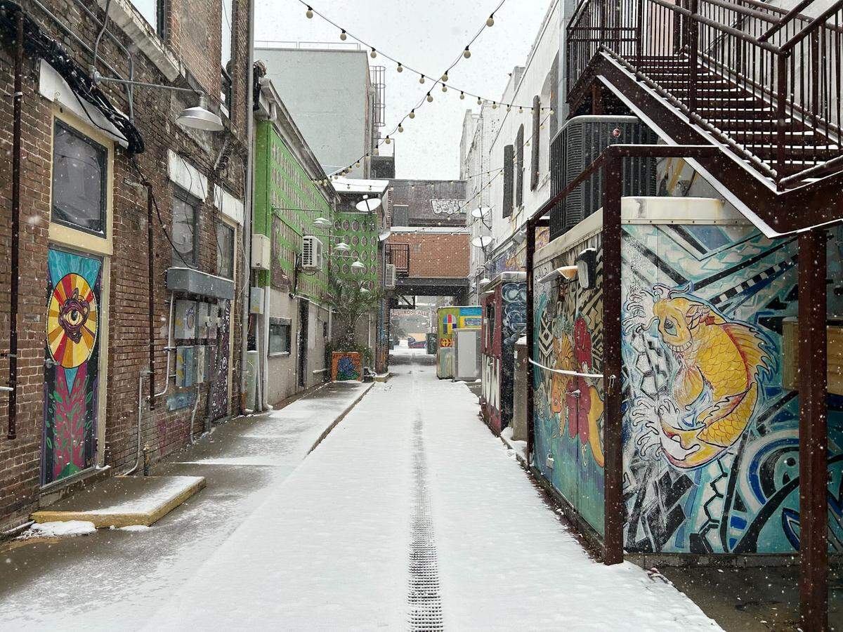 Downtown Gulfport was blanketed with snow on Tuesday and stores and offices are mostly closed Wednesday, with some beginning to reopen.