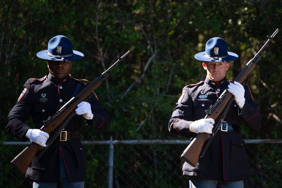 Members of the Mississippi Highway Patrol perform a 21-gun salute during the funeral for Joshua Brashears.