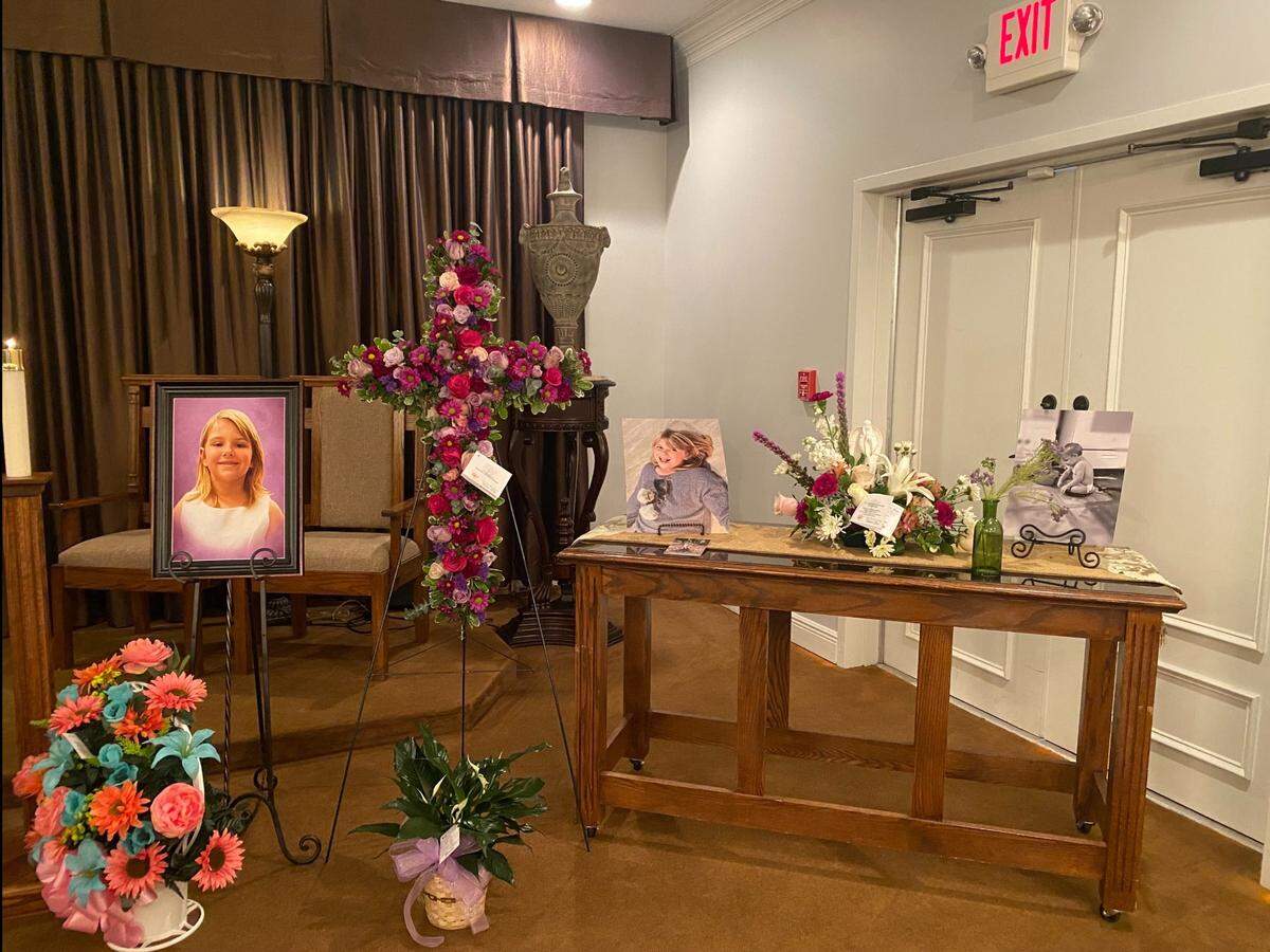 Pictures of Gracelynn Vick, 6, along with flowers and mementos, are spread out at Riemann Family Funeral Home in Gulfport for the child’s funeral service on Monday, April 21, 2024.