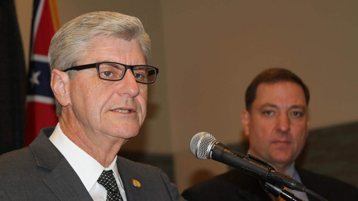 Gov. Phil Bryant, left, with Gary Rikard of the Mississippi Department of Environmental Quality, announces Mississippi Coast projects that will be funded through the Restore Act, including nine he selected from GoCoast 2020 Commission recommendations and four others approved by the Gulf Coast Ecosystem Restoration Council, which met in Biloxi on Wednesday.