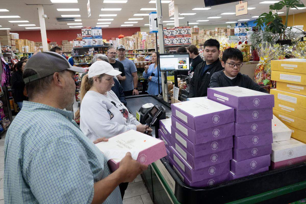 Stacy Rocha is the second person to purchase a king cake Friday at Lee’s International Market.