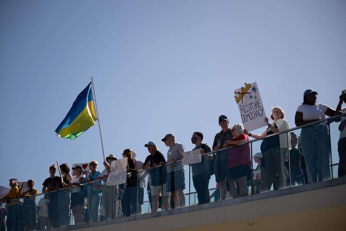 Protesters gather Saturday on a bridge to Jones Park.