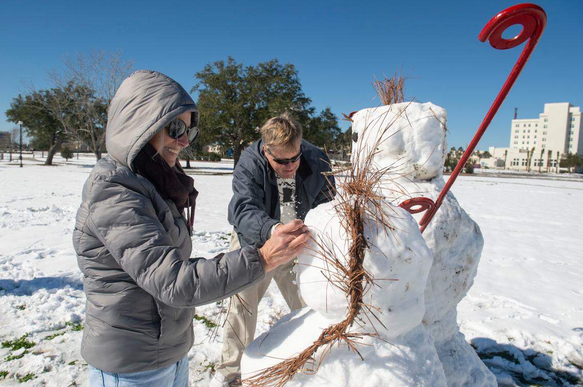 Stephanie and Mike Crow built a snowman on the beach Wednesday, Jan. 22, 2025, in Gulfport.