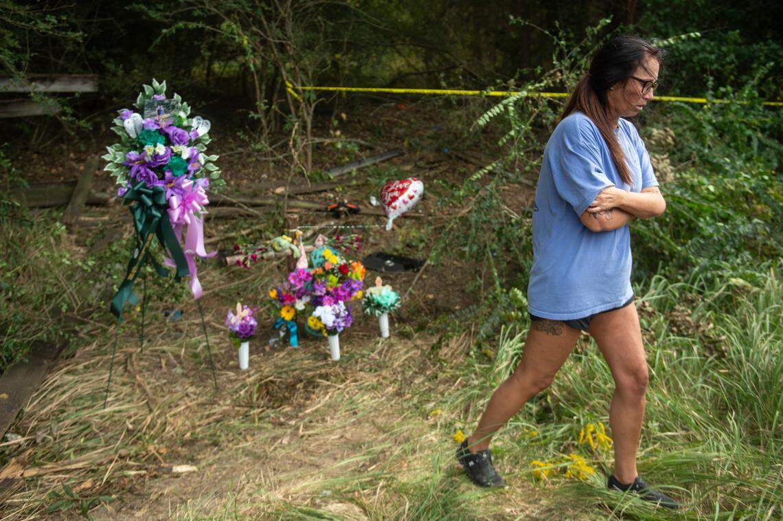 Chloe Taylor’s mother walks away from a memorial for her daughter and her daughter’s best friend, Baleigh Bowlin, at the site of a fatal car accident that claimed the lives of both girls off of Highway 613 in Hurley on Monday, Oct. 17, 2022.