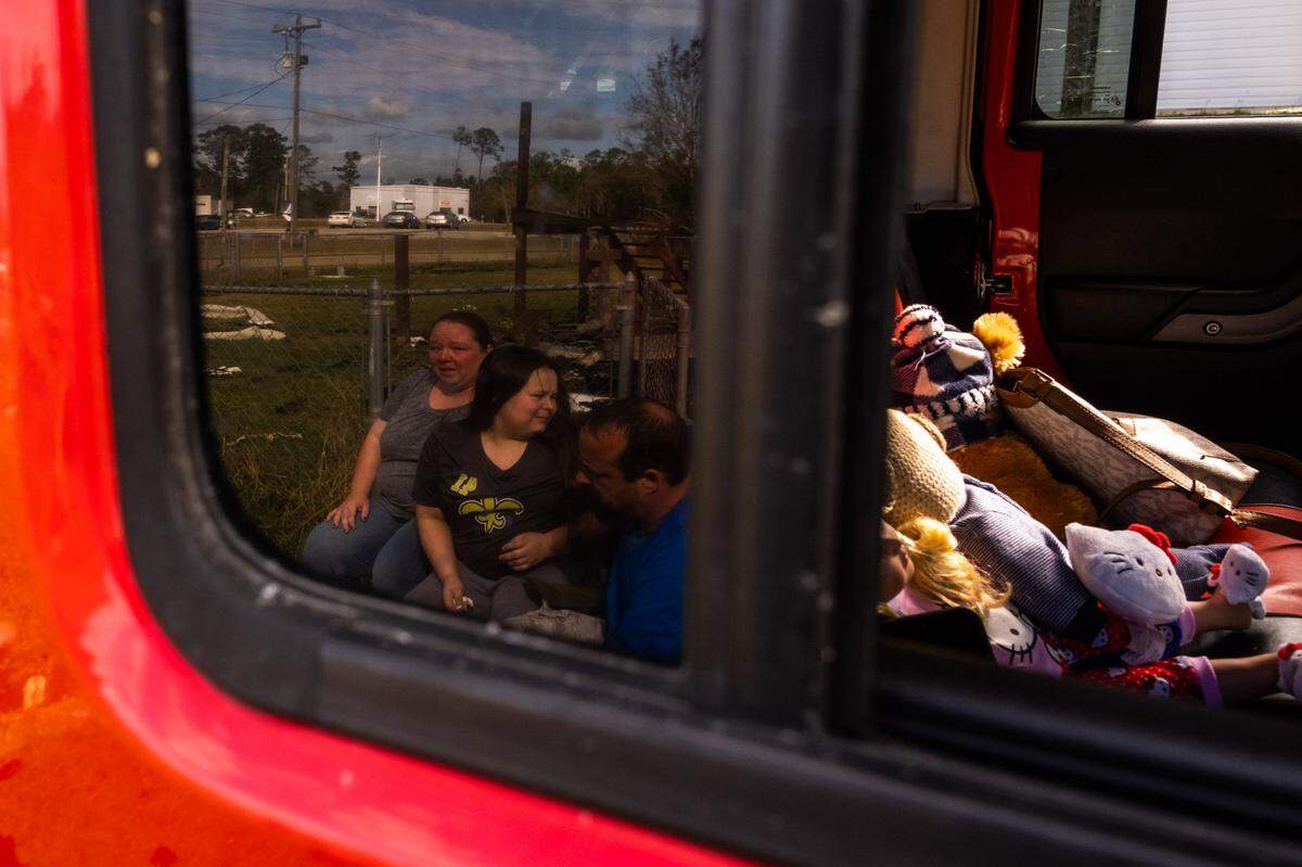 Abagail Turgeau emotionally reflects on the property of her family’s Hancock County home, which burned down during Hurricane Zeta, in the reflection of the family’s Jeep. After Hurricane Katrina destroyed their home in 2005, the Turgeaus lived in their Jeep for weeks.