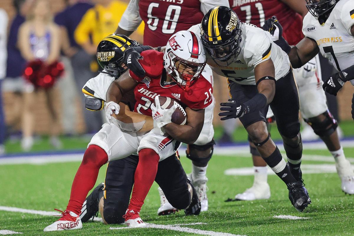 Southern Miss Golden Eagles defensive lineman Everitt Cunningham (5) comes in to assist in the tackle of South Alabama Jaguars running back Terrion Avery (25) during the game between Southern Miss and South Alabama at Hancock Whitney Stadium, Mobile, Alabama, September 4, 2021.