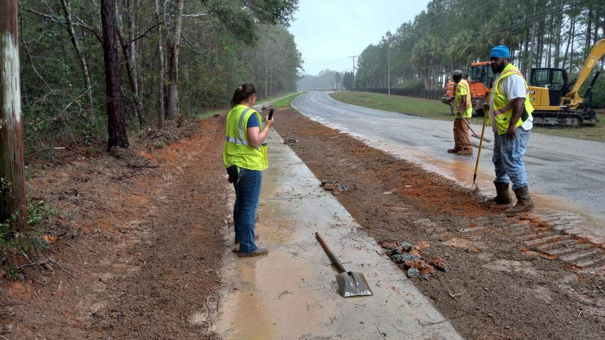 Workers with Moran Hauling work on sections of the sidewalk near Martin Bluff Elementary.