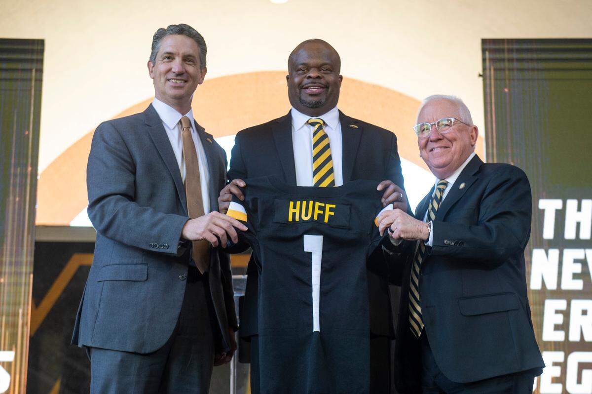 University of Southern Mississippi President Joseph Paul, right, Southern Miss Athletic Director Jeremy McClain, and new head football coach Charles Huff pose for a photo during a public welcome celebration for Huff at The Rock in Hattiesburg on Thursday, Dec. 12, 2024.