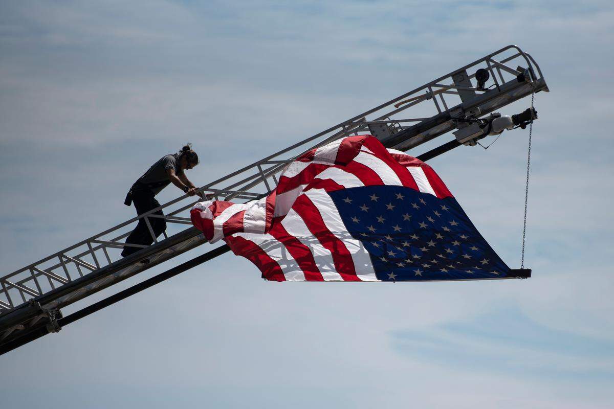 An American flag is flown off an Ocean Springs Fire Department truck on the anniversary of Hurricane Katrina at Fort Maurepas Park in Ocean Springs on Monday, Aug. 29, 2022.