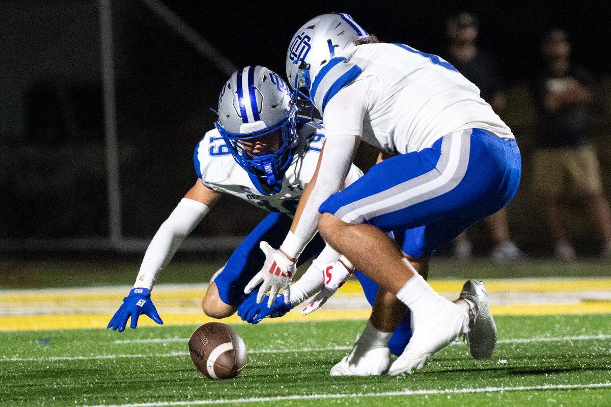 Ocean Springs safety Eli Chennault (19) and Ayden Watson (6) attempt to recover the ball after a blocked punt during a football game at Buddy Singleton Field on Friday, Oct. 10, 2025.