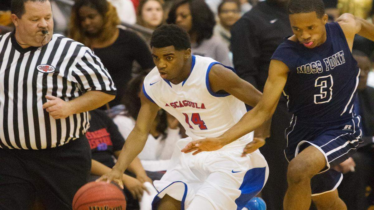 AMANDA McCOY/SUN HERALD 
 Pascagoula's Darius Johnson dribbles the ball down the court while guarded by Moss Point's Terrance Trussell during a game last season.