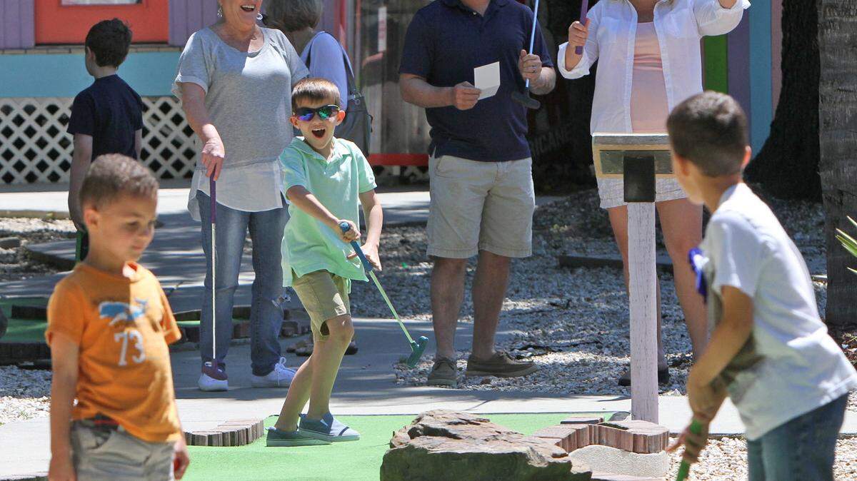 JOHN FITZHUGH/SUN HERALD/FILETy Riddle, 6, of Diamondhead and his family react to a hole-in-one while playing putt putt at Big Play Family Fun Center in Biloxi on May 2.