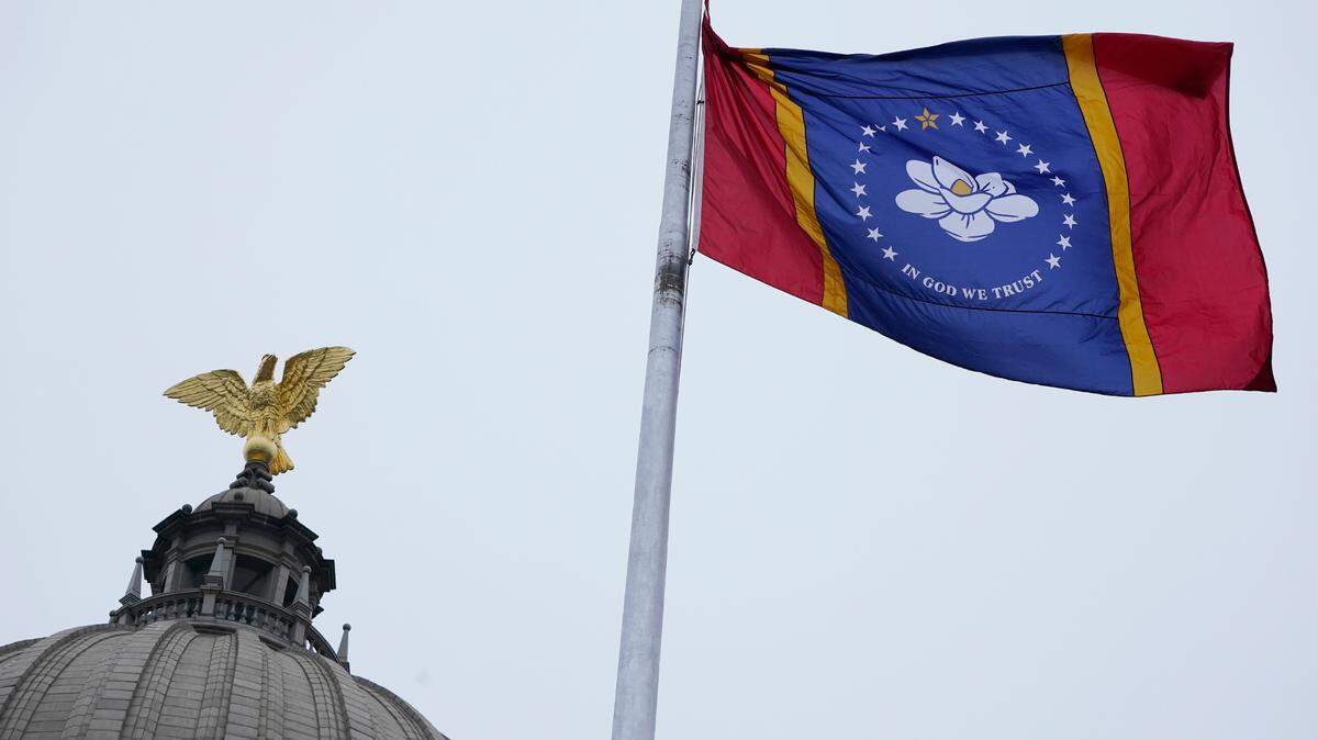 The new Mississippi state flag flies under the eagle at the top of the Capitol rotunda following the ceremonial unfurling in Jackson, Monday, Jan. 11, 2021. (AP Photo/Rogelio V. Solis)