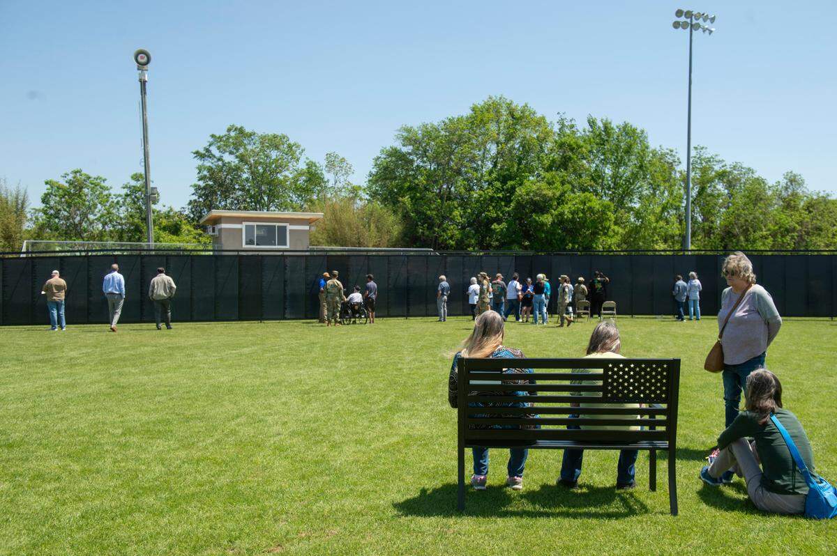Visitors visit The Wall That Heals, a traveling three-quarter scale replica of the Vietnam Veterans Memorial in D.C., while it is on display at the D’Iberville Sports Complex in D’Iberville on Thursday, April 10, 2025.