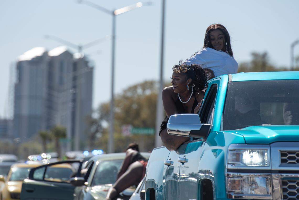 Spring breakers dance on top of cars as they sit in traffic along Highway 90 during Black Spring Break in Biloxi on Saturday, April 9, 2022.