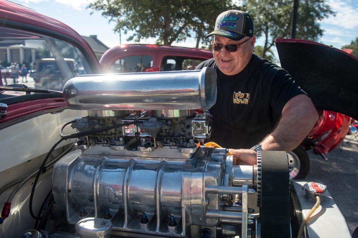 Martin Bishop polishes the engine on his 1952 Ford Anglia during View the Cruise at Cruisin’ The Coast in Gulfport on Sunday, Oct. 6, 2024. Bishop rebuilt the entire car except the original frame and a custom new engine.