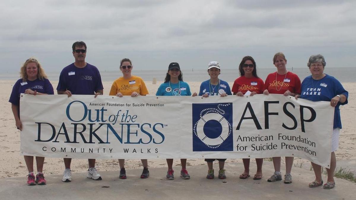 The Mississippi Chapter of the American Foundation for Suicide Prevention held its 2015 Mississippi Gulf Coast Out of the Darkness Walk in Gulfport. The 2016 walk will be Saturday, Sept. 10, starting at Ken Combs Pier in Gulfport. Board member Theresa Danko, fourth from left, and board chair Sherry Sheffield, second from right, are the volunteers planning the walk.