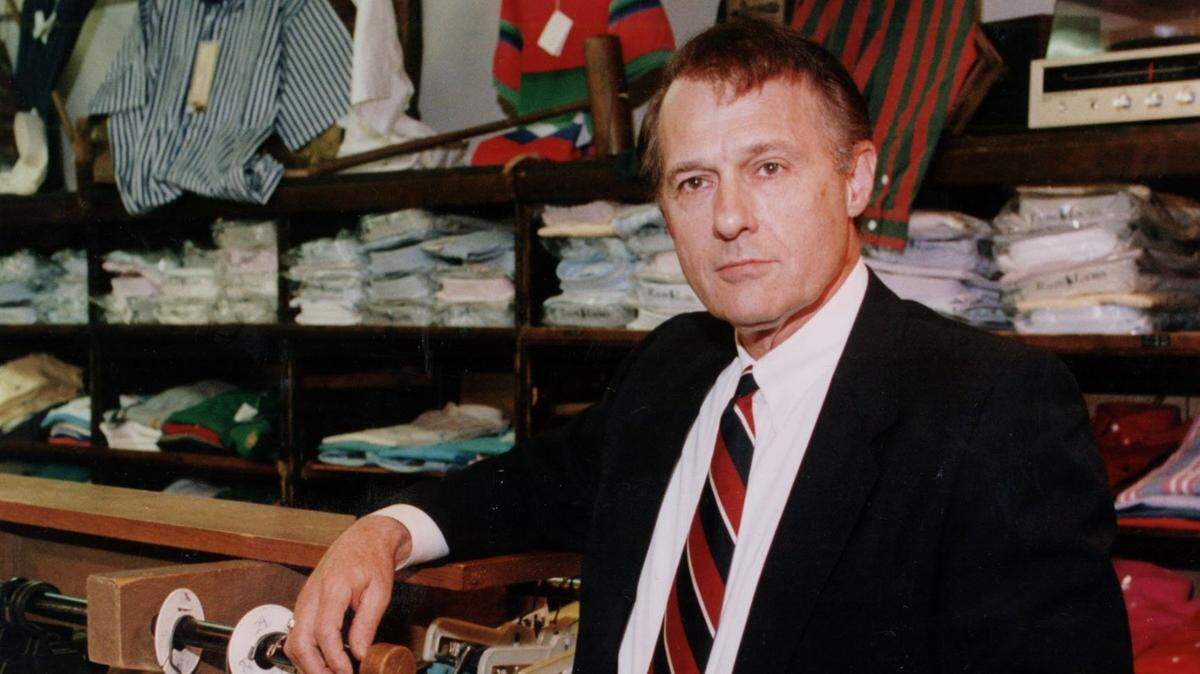 Gene Warr poses in his men’s clothing store, called Warr’s