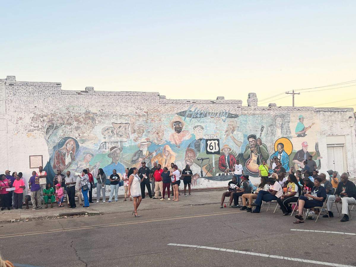 People participate in a candlelight vigil Monday in Leland to honor victims of gunfire that occurred days earlier during a homecoming block party.