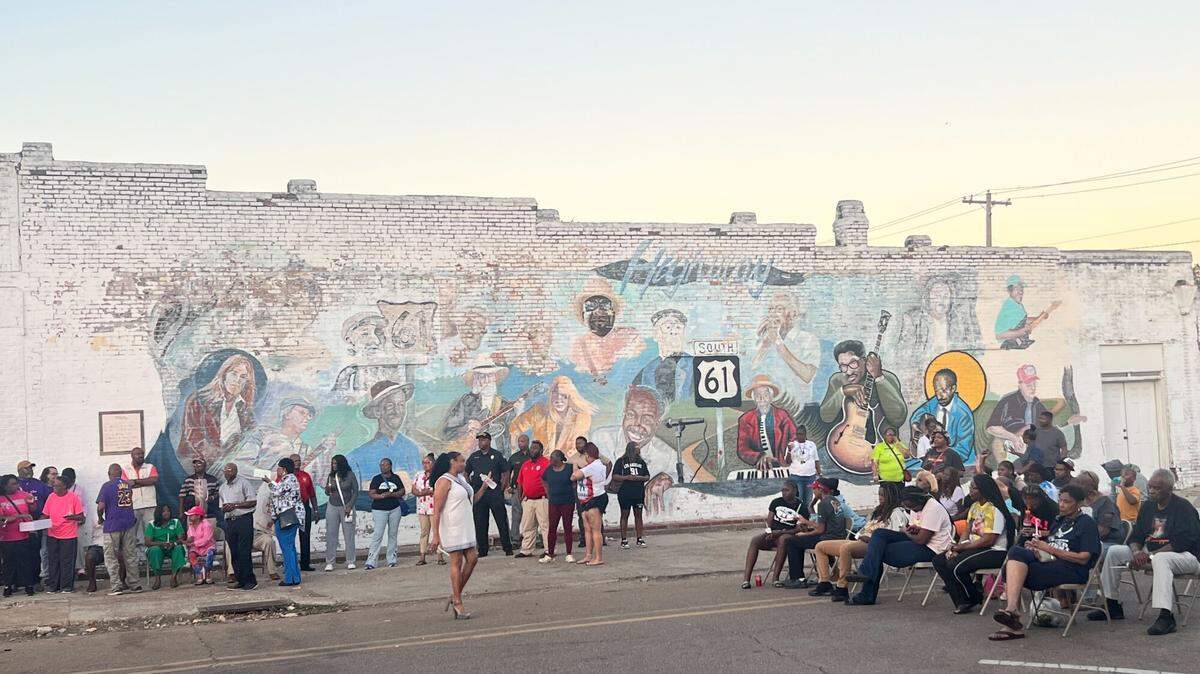 People participate in a candlelight vigil Monday in Leland to honor victims of gunfire that occurred days earlier during a homecoming block party.