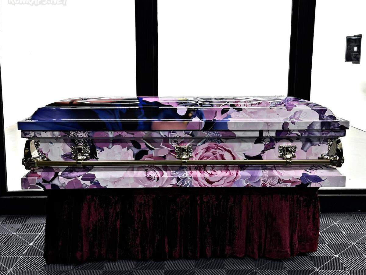 A garden of pink and purple flowers creates a tribute to the life of a young Gulfport victim of the New Year’s Day terrorist attack. The casket wrap was made by a Gulfport man who did the first wrap three years ago after his sister died.