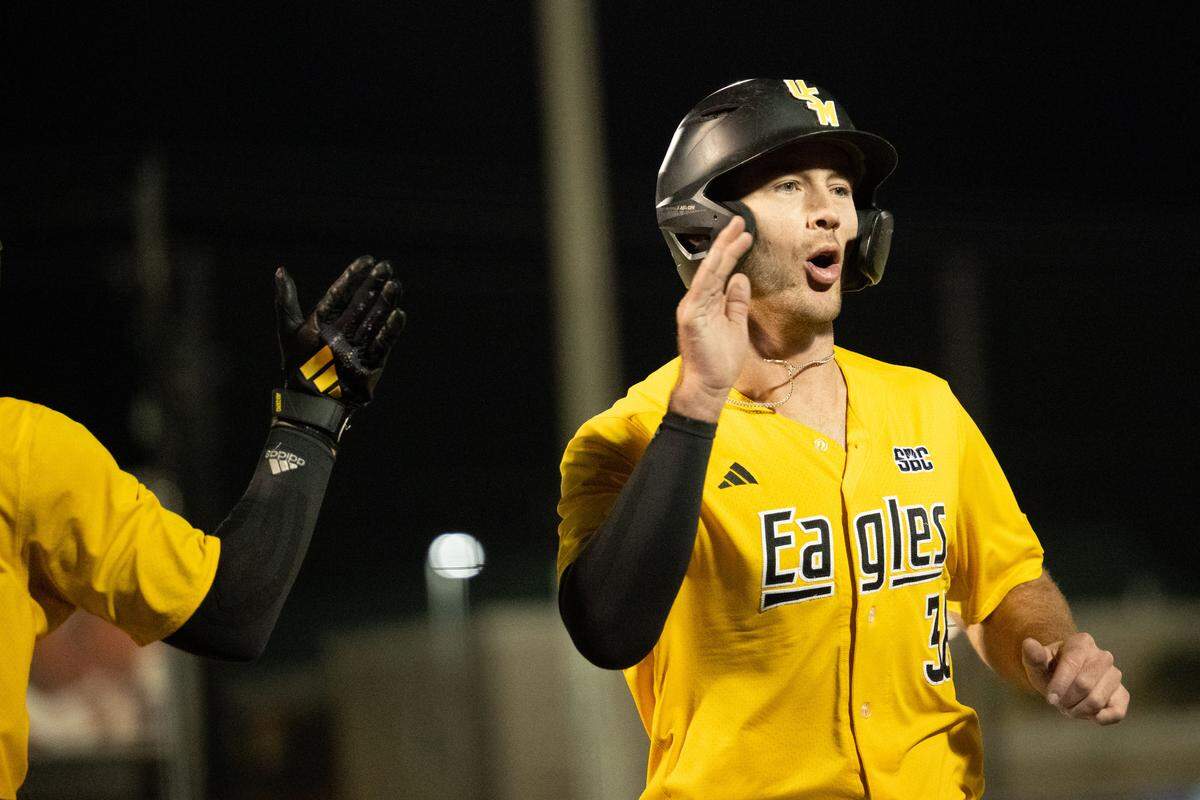 Southern Miss catcher Tucker Stockman (36) high-fives outfielder Joey Urban (1) after scoring Tuesday.