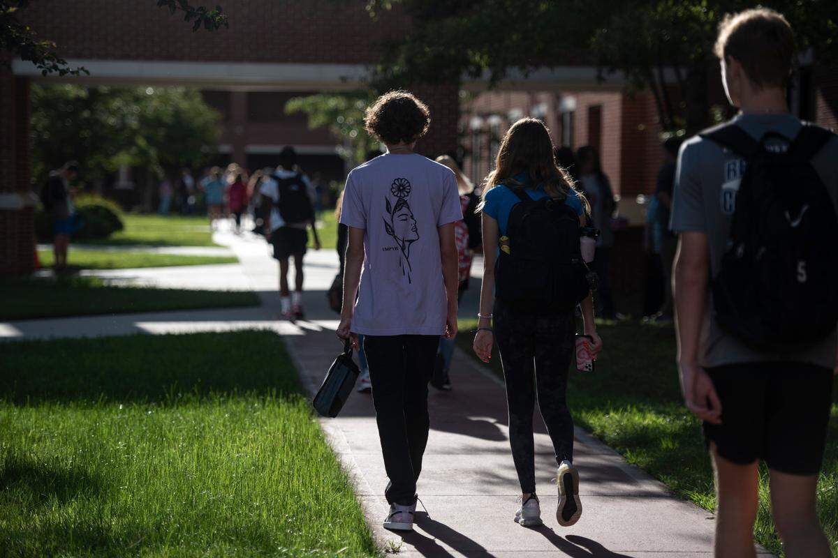 High school students walk to their first class on the first day of school at Ocean Springs High School in Ocean Springs on Friday, Aug. 5, 2022.