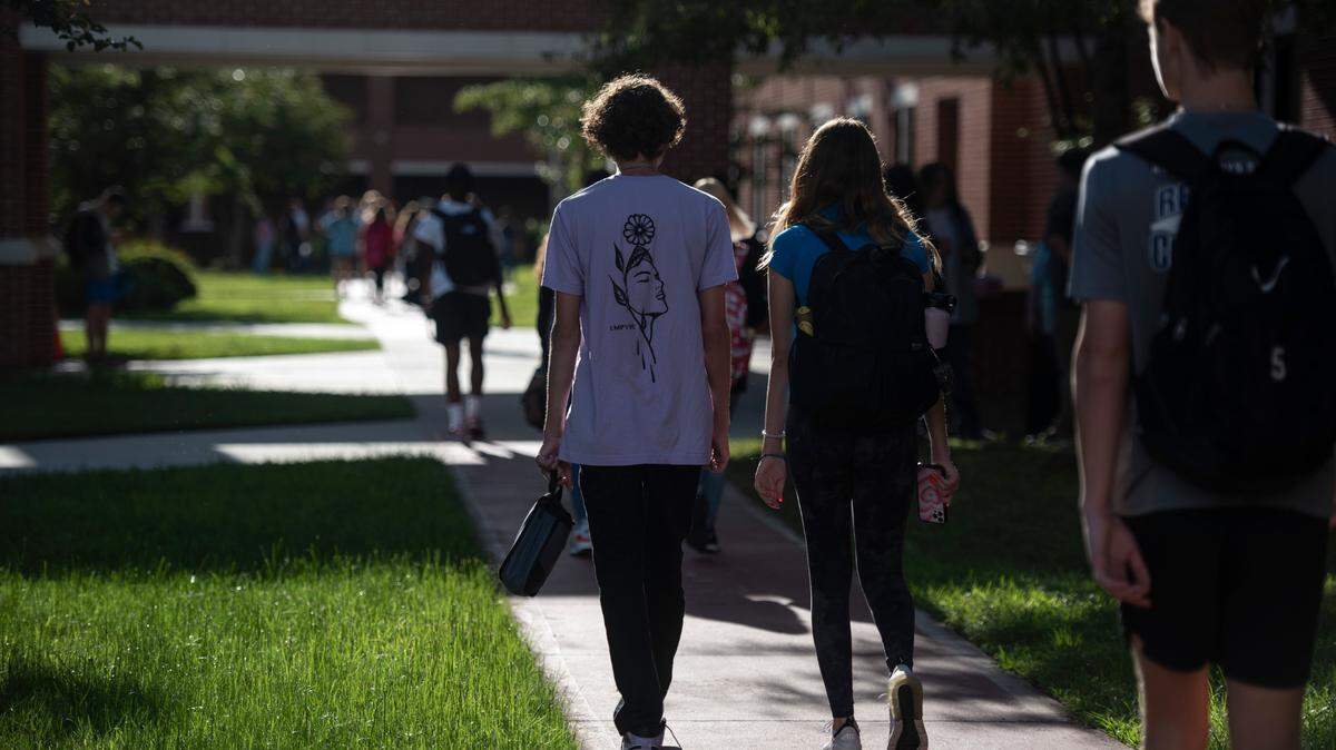High school students walk to their first class on the first day of school at Ocean Springs High School in Ocean Springs on Friday, Aug. 5, 2022.