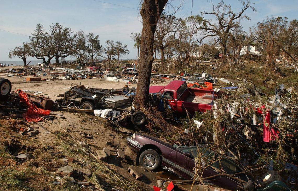 Mangled vehicles lie among piles of debris from homes and other buildings at the intersection of Porter Avenue and Beach Blvd. in Biloxi.