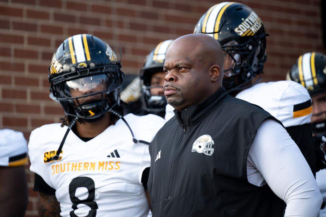 Southern Mississippi head coach Charles Huff stands with his team as they walk onto the field.