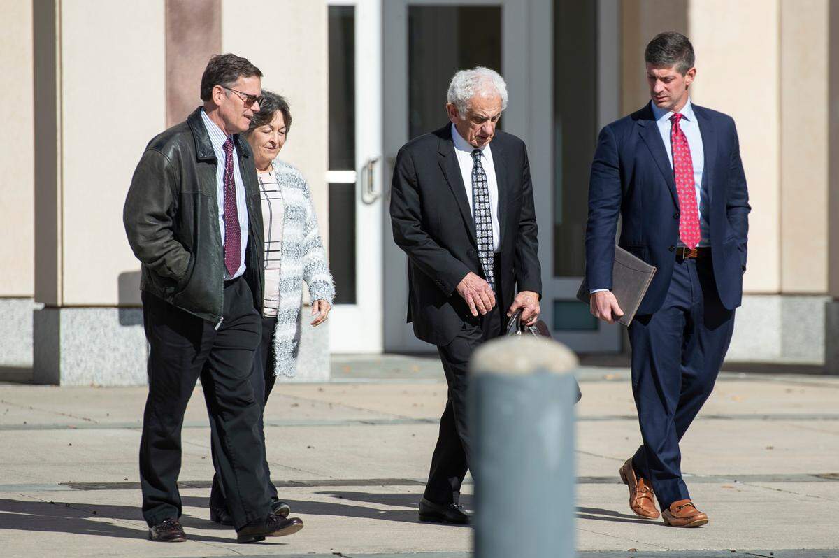 James “Jim” Gunkel, left, business manager of Quality Poultry & Seafood, walks out of the federal courthouse in Gulfport with his attorneys on Wednesday, Dec. 11, 2024, after his sentencing in a federal seafood mislabeling case.