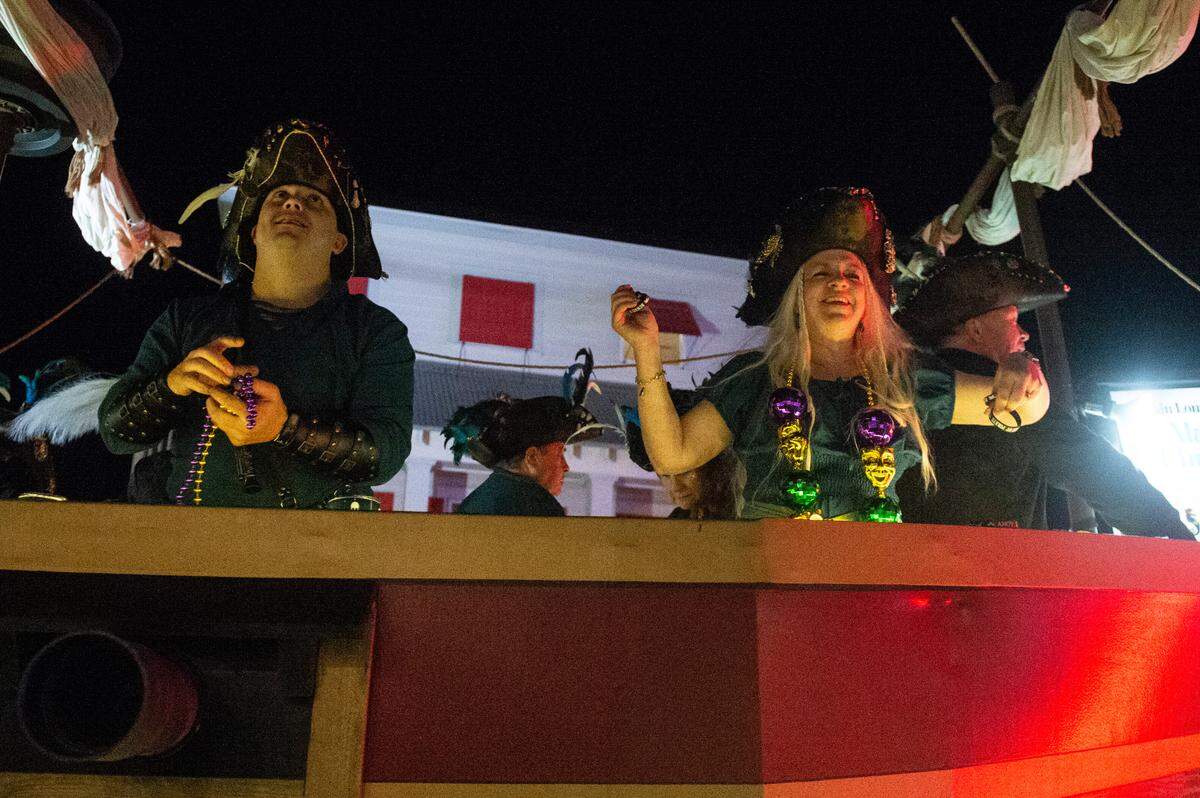 Members of Mystic Krewe of the Seahorse throw beads during the krewe’s Lundi Gras parade in Bay St. Louis on Monday, March 3, 2025.