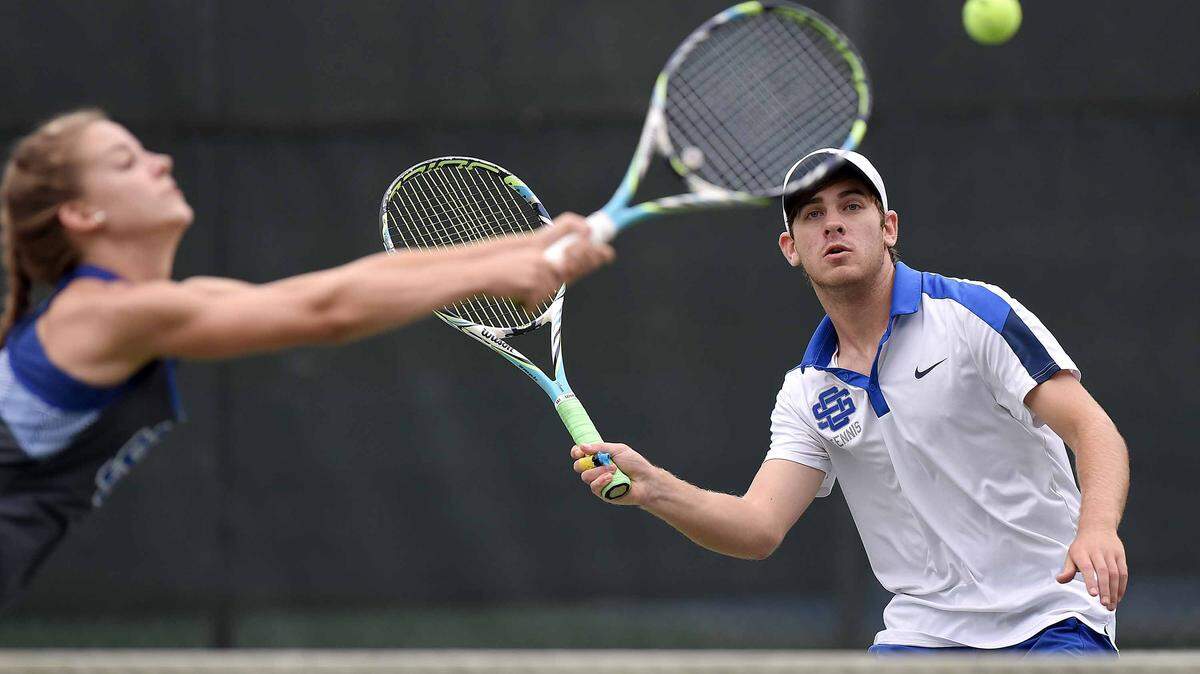 Ocean Springs' Lukas Wicht Evans (right) watches his mixed doubles partner Rachel Broome jump on a return at the net against Madison Central on Monday, May 9, 2016, at the MHSAA Class 5A and 6A State Tennis Team Championships at Parham Bridges Tennis Center in Jackson, Miss.