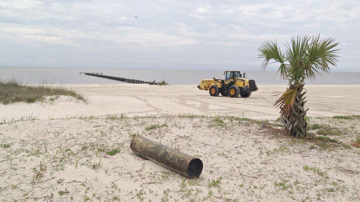 MARY PEREZ/SUN HERALD 
 Harrison County Sand Beach Authority crews tidy the beach Tuesday. Supervisor Beverly Martin said crews now will work weekends during special events and holidays to get the litter cleaned up quickly.