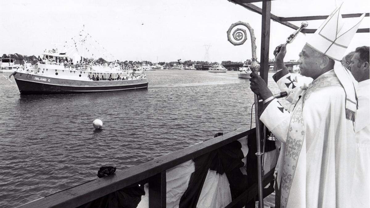 Bishop Joseph Howze blessed a passing boat at the Biloxi Blessing of the Fleet on May 31, 1997.