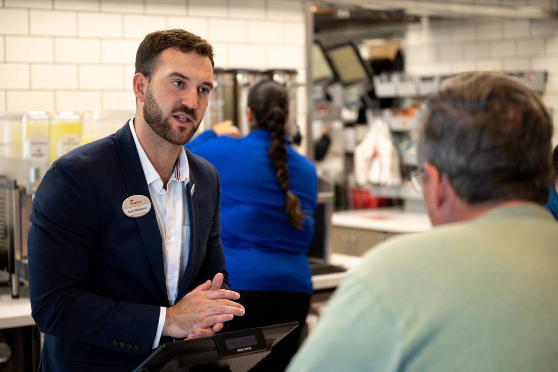 Cade Williamsen, left, takes an order from a customer Wednesday.