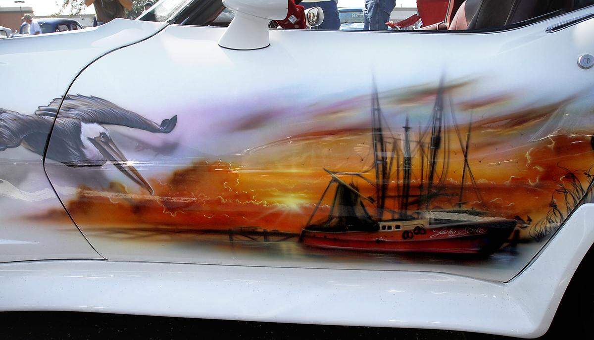 The driver's side door of Leon Hagwood's Corvette features a mural of a pelican and a shrimp boat. 