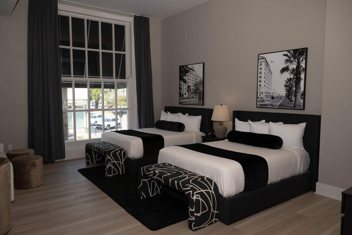 A double queen bedroom has a connecting king suite for those looking for luxurious accommodations at the Markham Hotel in Gulfport.