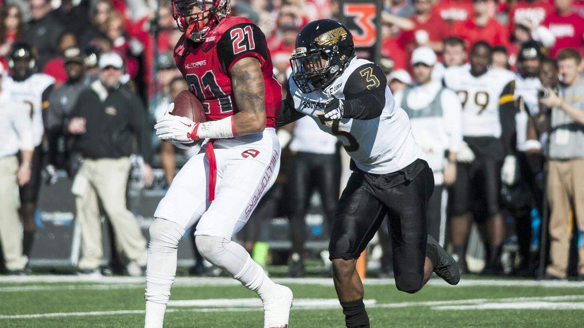 Western Kentucky wide receiver Jared Dangerfield (21) is tackled by Southern Mississippi Golden Eagles defensive back Cornell Armstrong (3) during Western Kentucky's 45-28 win against Southern Miss in the Conference USA championship NCAA college football game in Bowling Green, Ky., Saturday, Dec. 5, 2015. (Austin Anthony /Daily News via AP) MANDATORY CREDIT