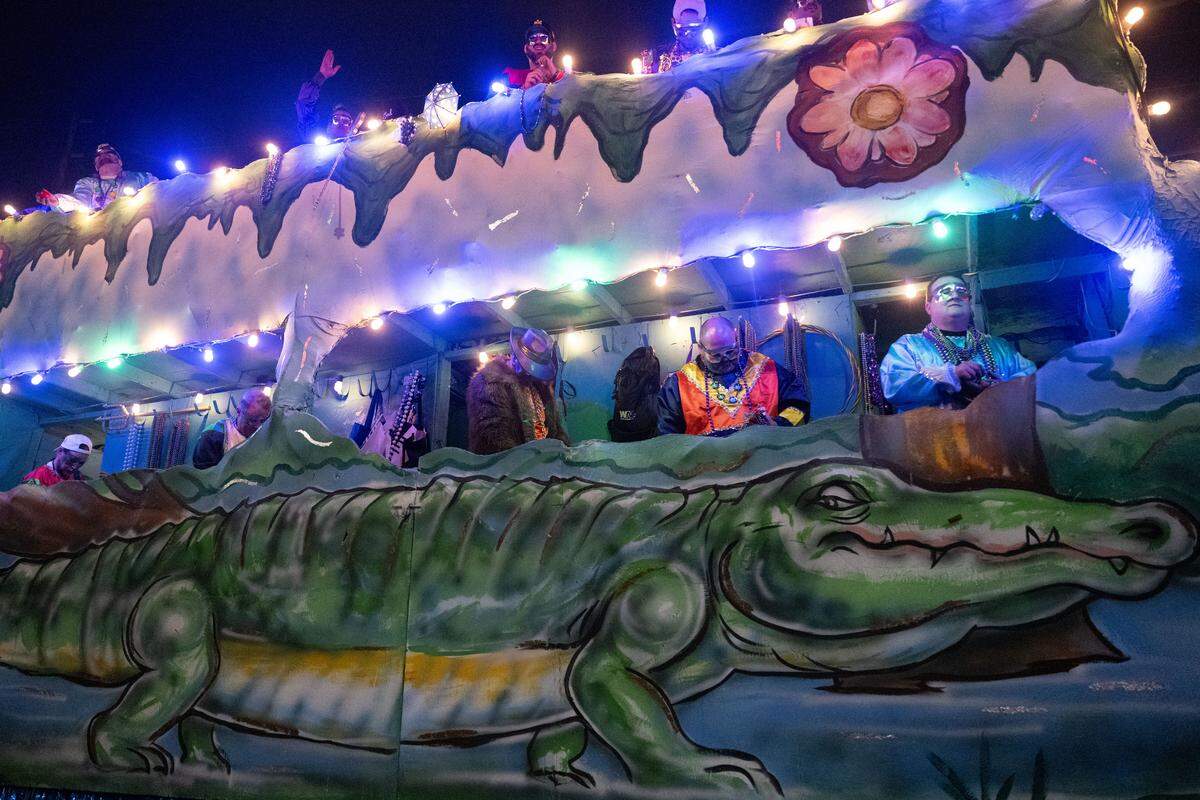 An alligator themed float drives through during the Krewe of Neptune parade in Biloxi on Saturday, Feb. 14, 2026.