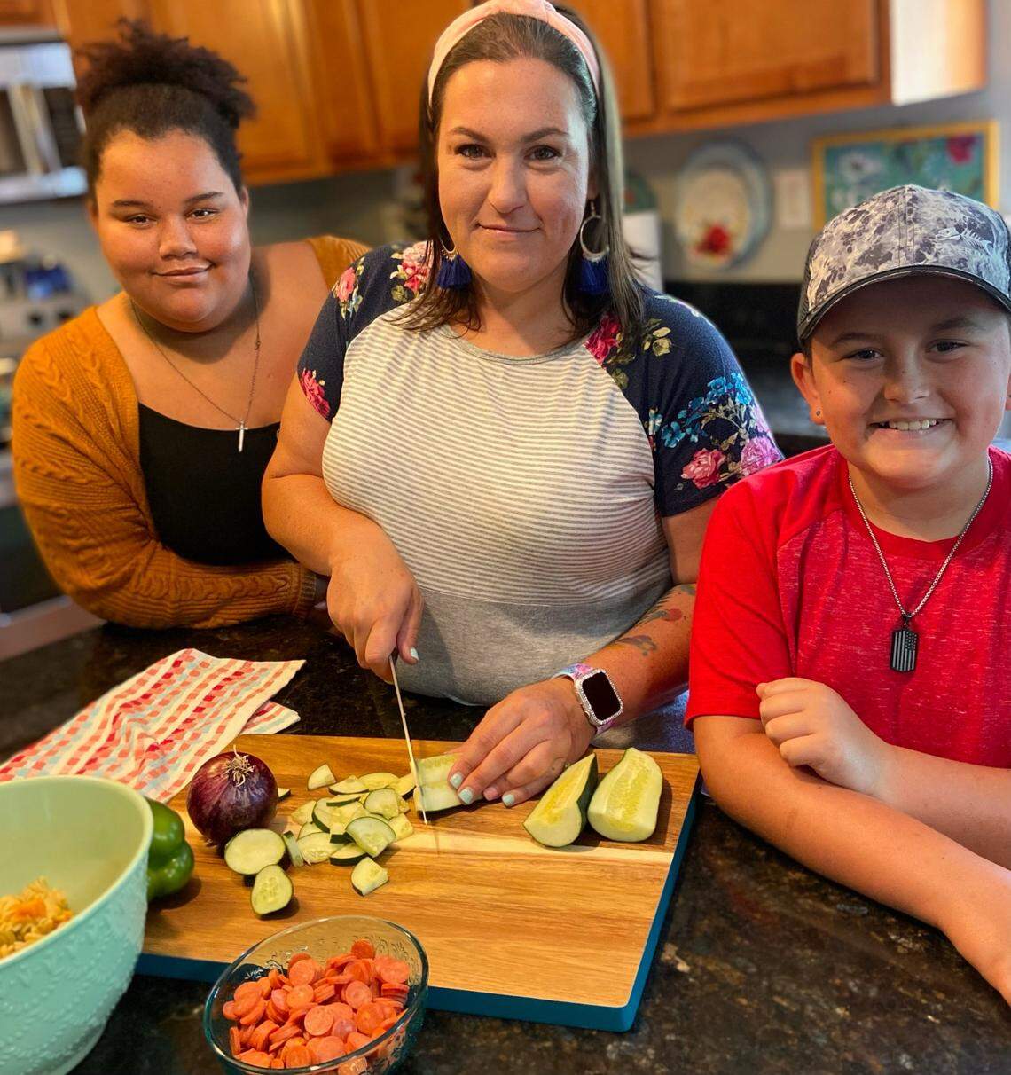 Caroline Davis, also known as @mississippi_kween, with two of her four children. Bubba, pictured on the right, makes frequent appearances in Davis’s TikTok videos.