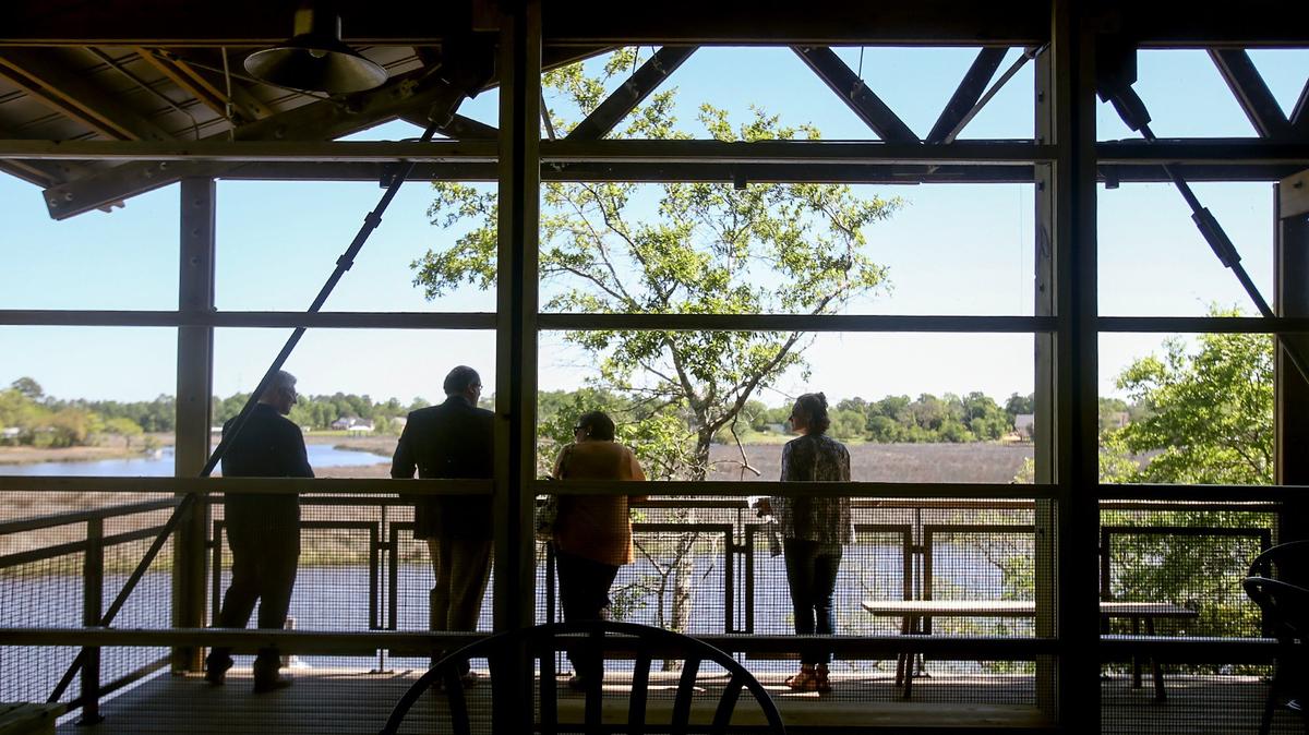 Visitors tour the new University of Southern Mississippi’s Marine Education Center at the Gulf Coast Research Laboratory Cedar Point Site on April 16, 2018. The facility features many boardwalks and trails conducive to outdoor learning, such as the pavilion that overlooks Davis Bayou.