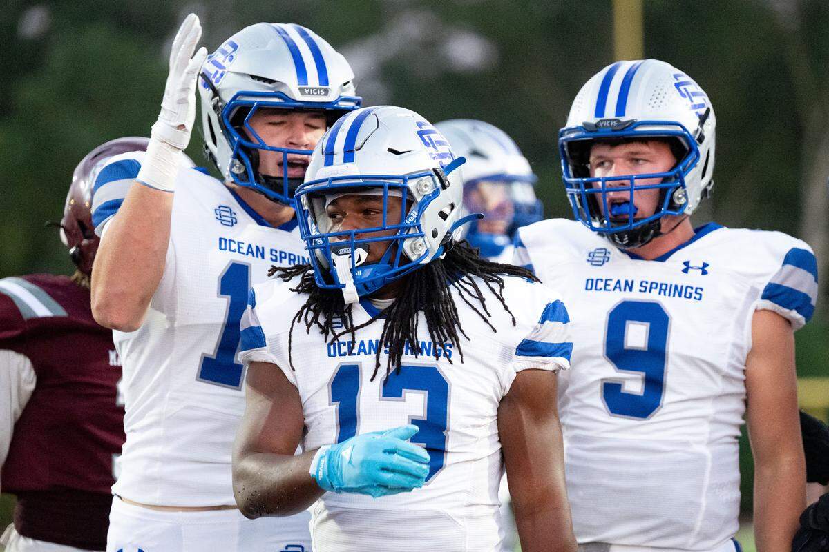 Ocean Springs running back Solomon Baggett (13) celebrates with his teammates after scoring a touchdown Friday in a 56-42 win over Picayune.