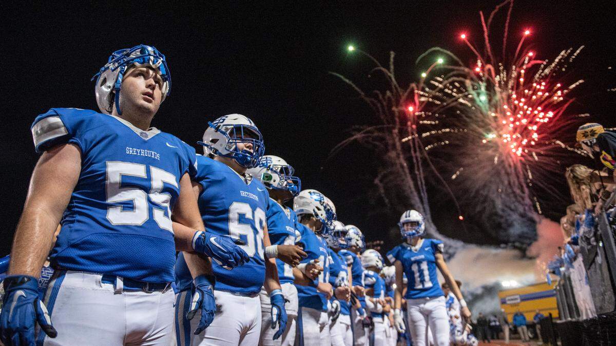 The Ocean Springs Greyhounds stand for their alma mater after beating the Pearl Pirates in the first round of playoffs at Greyhound Stadium in Ocean Springs on Friday, Nov. 12, 2021.
