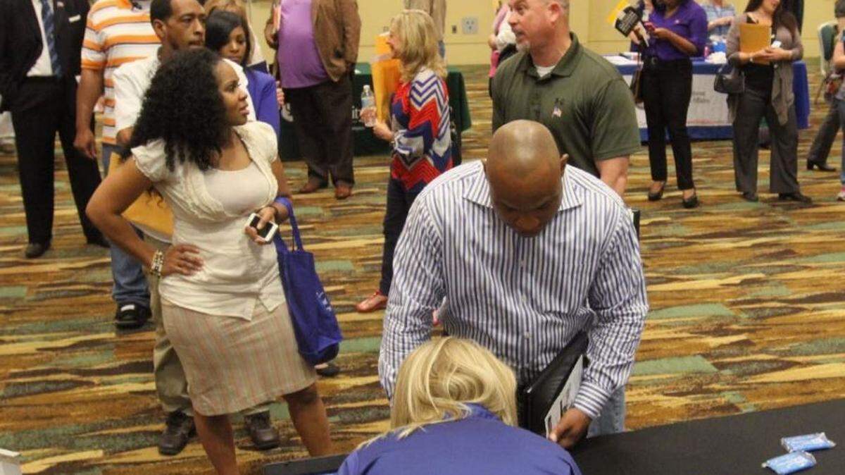 People stand in line at a job fair at the Coast Coliseum. Today, online listings show some jobs that pay more than $50,000 a year if you have the right experience.